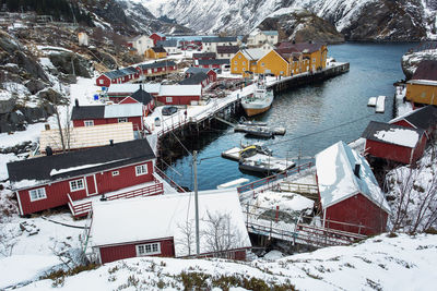 High angle view of houses by sea during winter