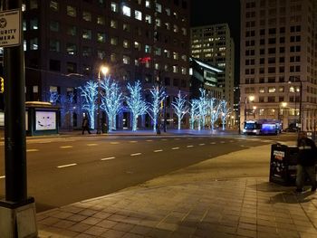 Illuminated city street and buildings at night