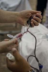 Cropped hands of doctor holding iv drip