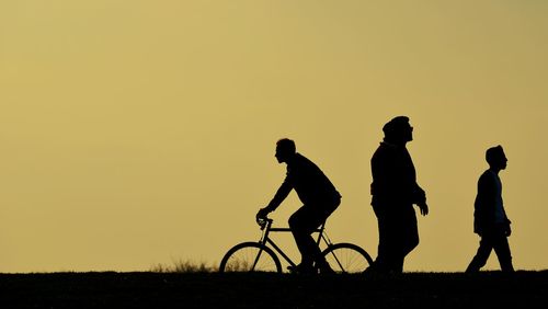 Silhouette of man against clear sky at sunset