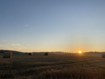 Scenic view of field against sky during sunset