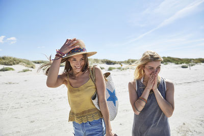 Two happy female friends on the beach