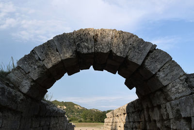 Low angle view of old ruins against sky