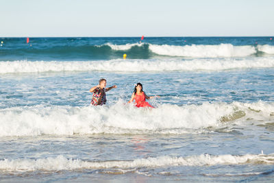 People on beach against sky