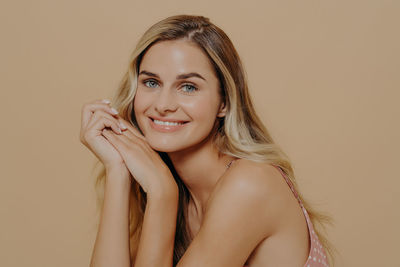 Portrait of young woman against white background