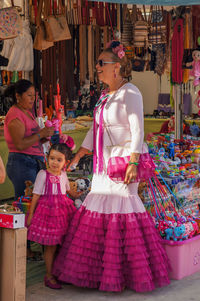 Women standing at market stall