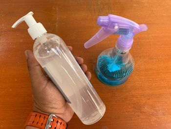 High angle view of hand holding bottle
