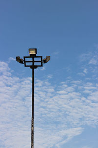 Low angle view of cross sign against blue sky