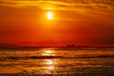 Scenic view of sea against orange sky