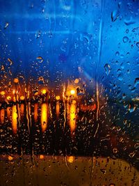Full frame shot of wet glass window in rainy season