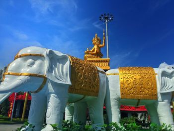 Low angle view of statue against temple against sky