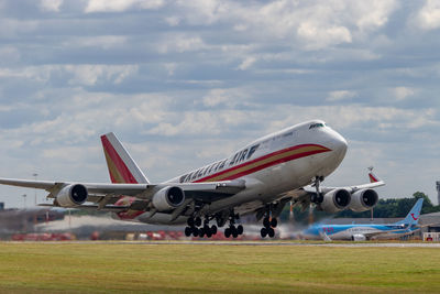 Airplane on runway against sky