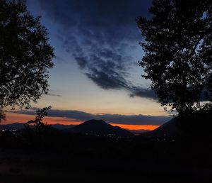 Scenic view of silhouette mountains against sky at sunset