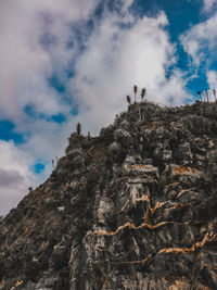 Low angle view of rocky mountain against sky