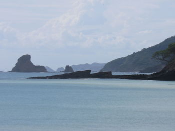 Scenic view of sea and mountains against sky