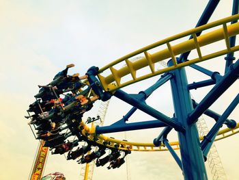 Low angle view of amusement park ride against sky