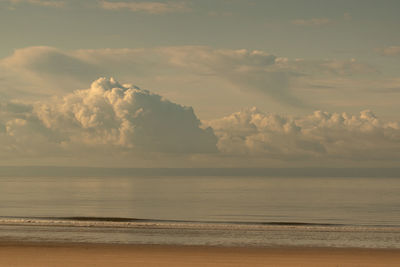 Scenic view of sea against sky with large low clouds