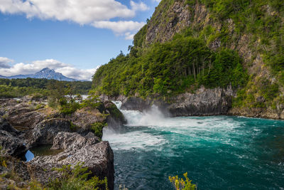 Scenic view of waterfall against sky