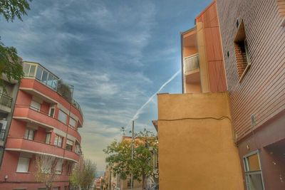 Low angle view of building against cloudy sky