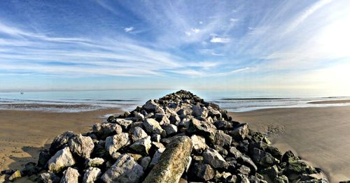 Rocks on beach against sky