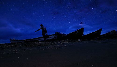 Low angle view of illuminated stars in the dark