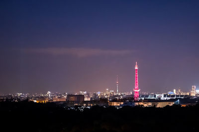 View of illuminated cityscape against sky at night