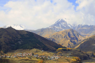 Scenic view of mountains against cloudy sky