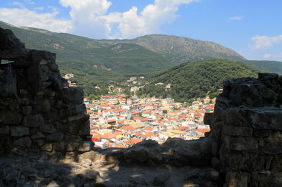 High angle view of town against forest mountain