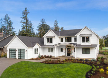 Beautiful modern farmhouse style luxury home exterior with blue sky