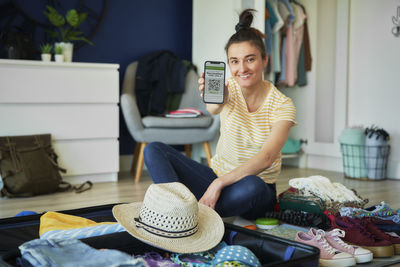 Side view of young woman sitting at home