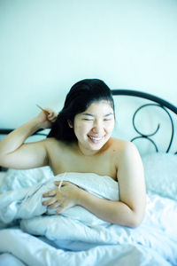 Young woman lying on bed