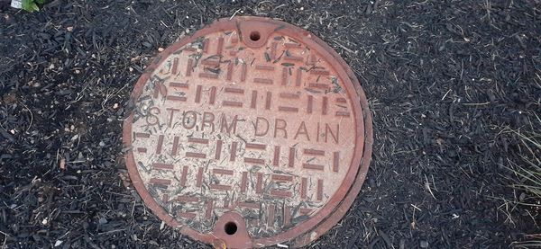 High angle view of text on manhole