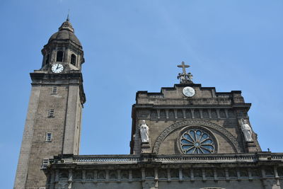 Low angle view of clock tower against sky