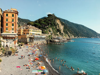 Scenic view of sea by buildings against clear sky