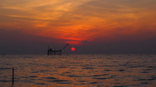 Scenic view of sea against orange sky