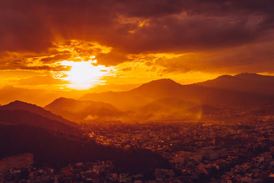 Aerial view of cityscape against sky during sunset