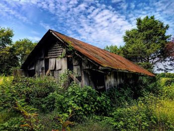 House by trees against sky