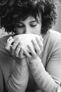 Portrait of woman drinking coffee