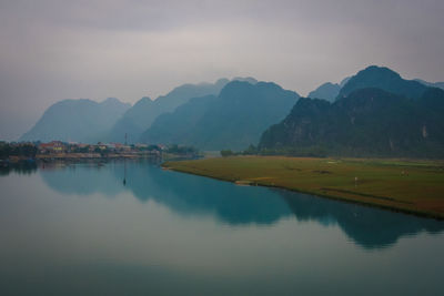 Scenic view of lake and mountains against sky