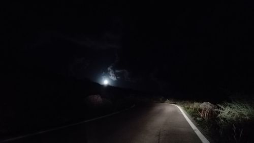 Road against sky at night