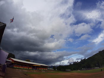 Low angle view of buildings against cloudy sky