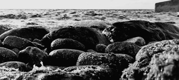 Rocks in sea against sky