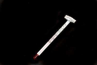 High angle view of cigarette on table against black background