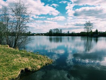 Scenic view of lake against cloudy sky