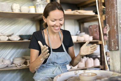 Smiling woman working in pottery