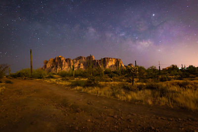 Scenic view of land against sky at night