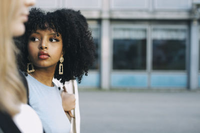 Female friends looking away while hanging out
