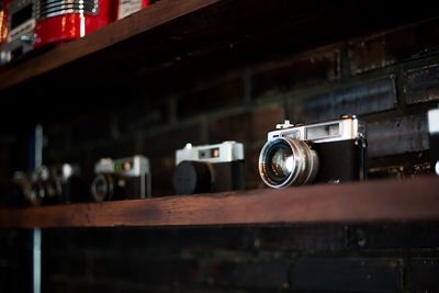 Low angle view of cameras on shelf