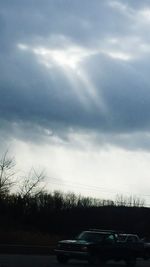 View of road against cloudy sky at sunset