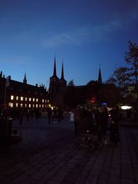 Silhouette of people on street at night